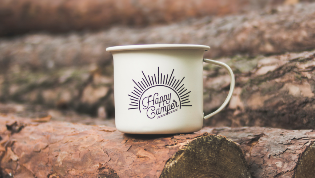 A mug that says happy camper.
