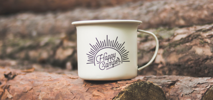 A mug that says happy camper.